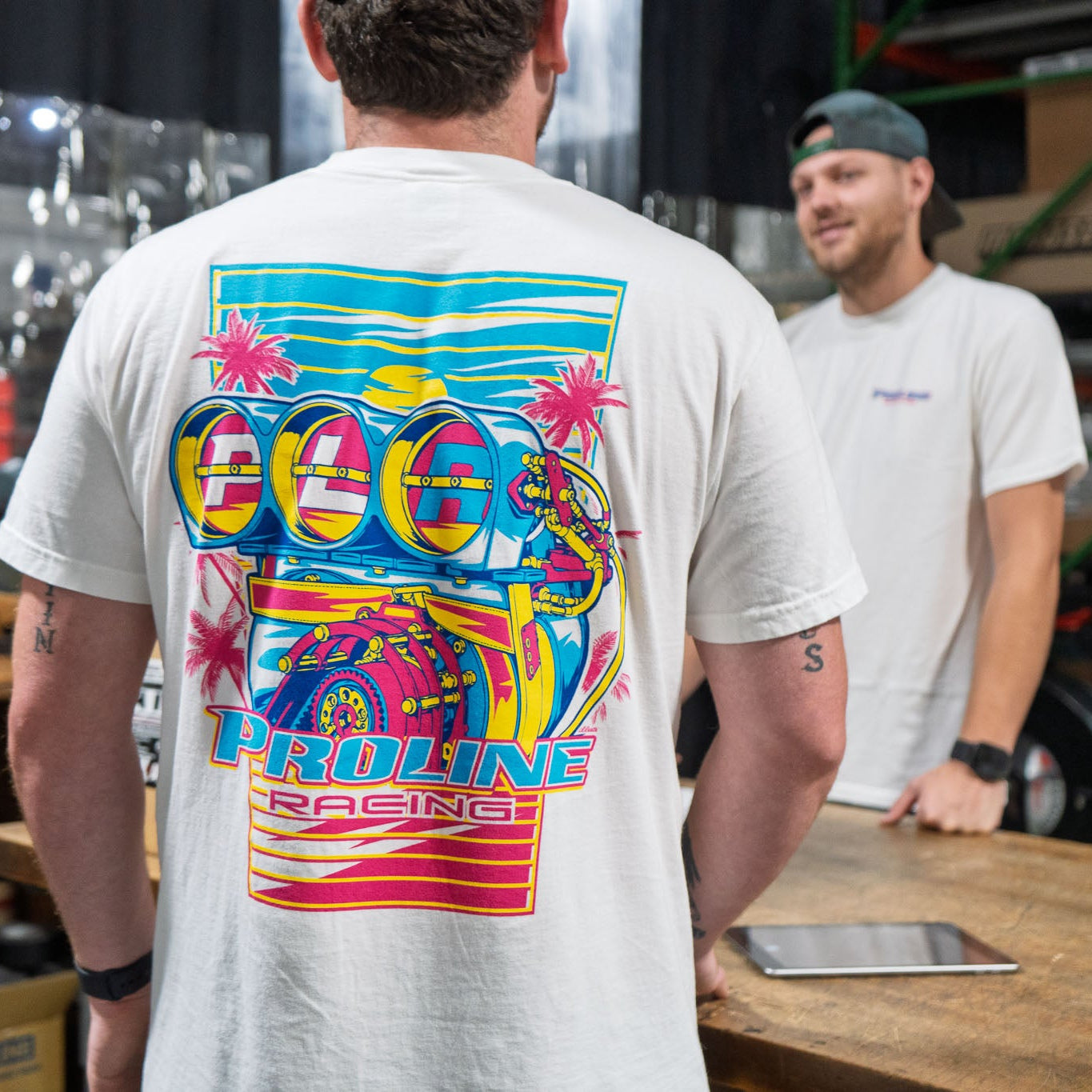 White short-sleeve t-shirt shown from both front and back. The front features a small blue and red 'Proline' logo on the left chest.